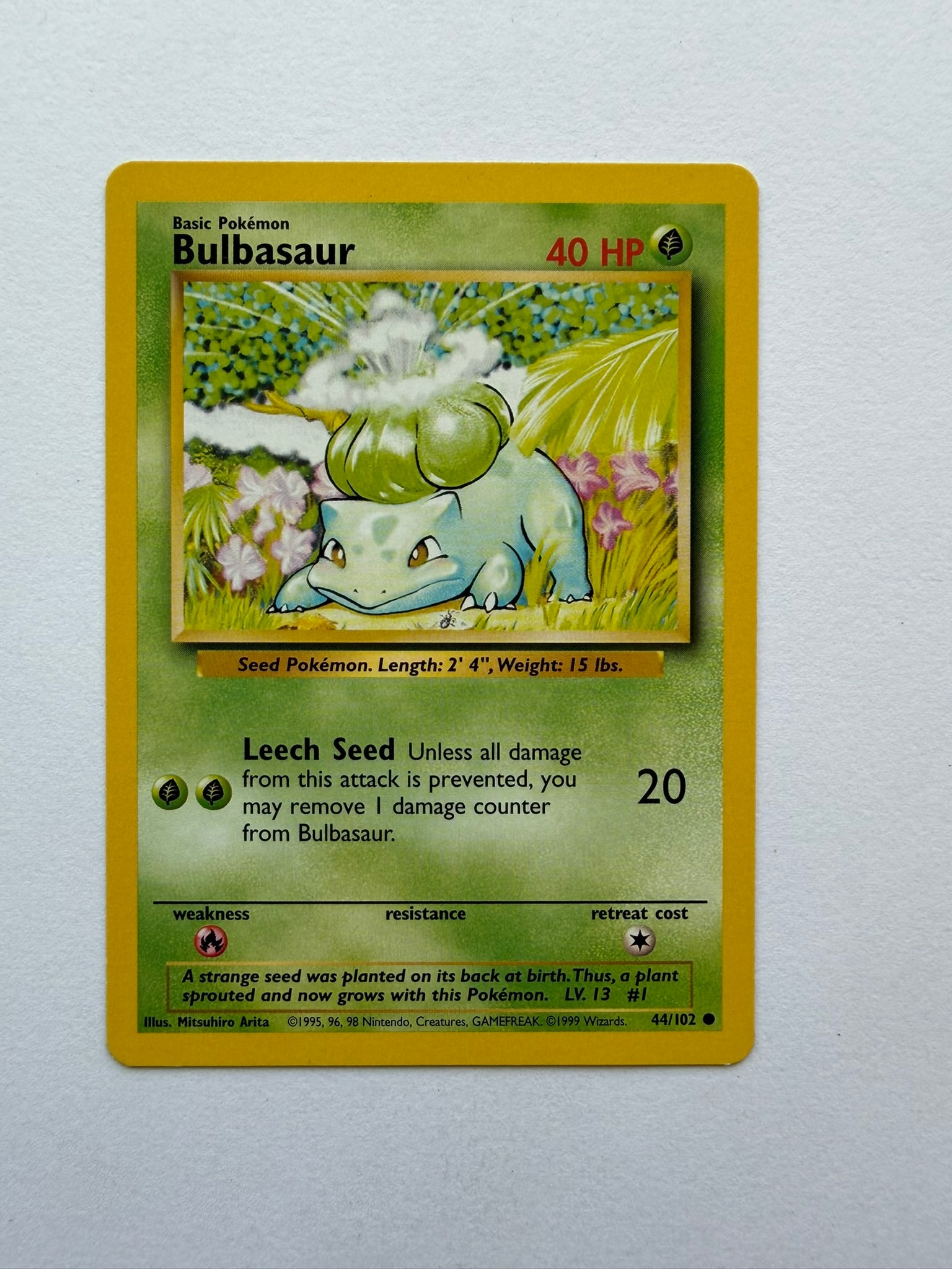 1999 Pokemon Bulbasaur 44/102 Base Set: Original Bulbasaur 44/102 from the 1999 Pokemon Base Set. Unlimited non-holo common featuring classic Mitsuhiro Arita artwork. Ungraded with visible edge and surface wear.