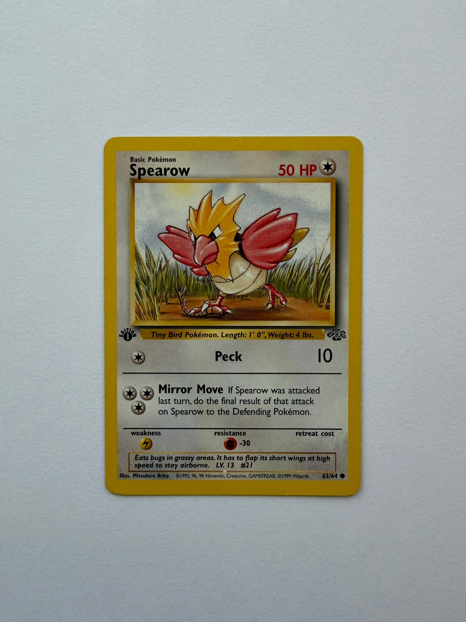 1999 Pokemon Spearow 62/64 Jungle 1st Edition: Vintage Spearow 62/64 from the 1999 Pokemon Jungle expansion. English 1st Edition common featuring artwork by Mitsuhiro Arita. Ungraded with visible age-related edge and surface wear. Please review ph