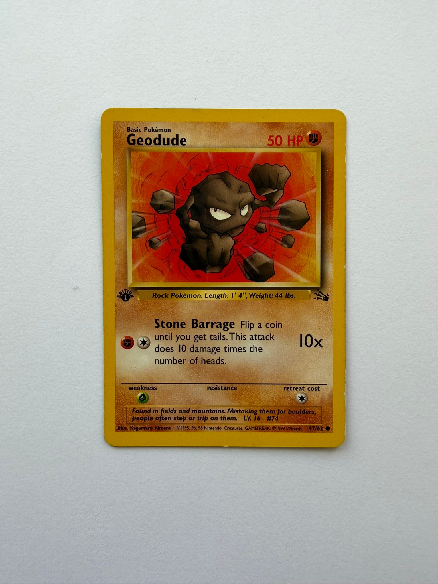 1999 Pokemon Geodude 47/62 Fossil 1st Edition: Vintage Geodude 47/62 from the 1999 Pokemon Fossil expansion. English 1st Edition common featuring artwork by Kagemaru Himeno. Ungraded with visible age-related edge and surface wear. Please review ph