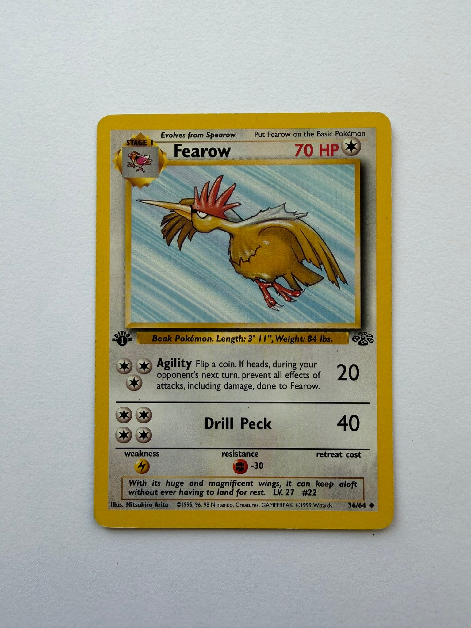 1999 Pokemon Fearow 36/64 Jungle 1st Edition: Vintage Fearow 36/64 from the 1999 Pokemon Jungle expansion. English 1st Edition non-holo uncommon featuring artwork by Mitsuhiro Arita. Ungraded with visible edge and surface wear. Please review phot