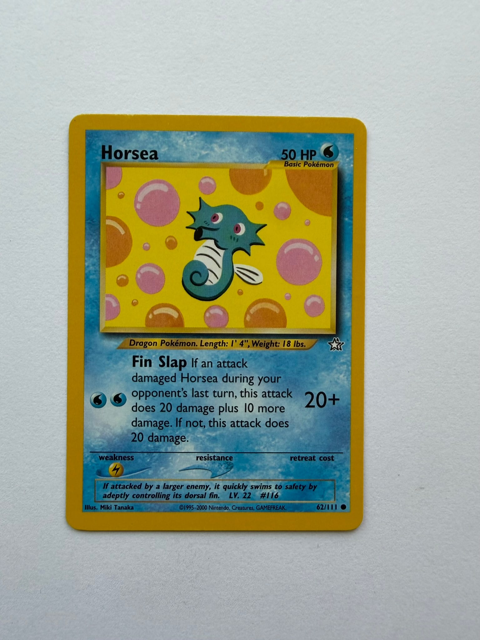 2000 Pokemon Horsea 62/111 Neo Genesis: Vintage Horsea 62/111 from the 2000 Pokemon Neo Genesis expansion. Unlimited non-holo common featuring colorful Miki Tanaka artwork. Ungraded with visible edge and surface wear. Please review photogra