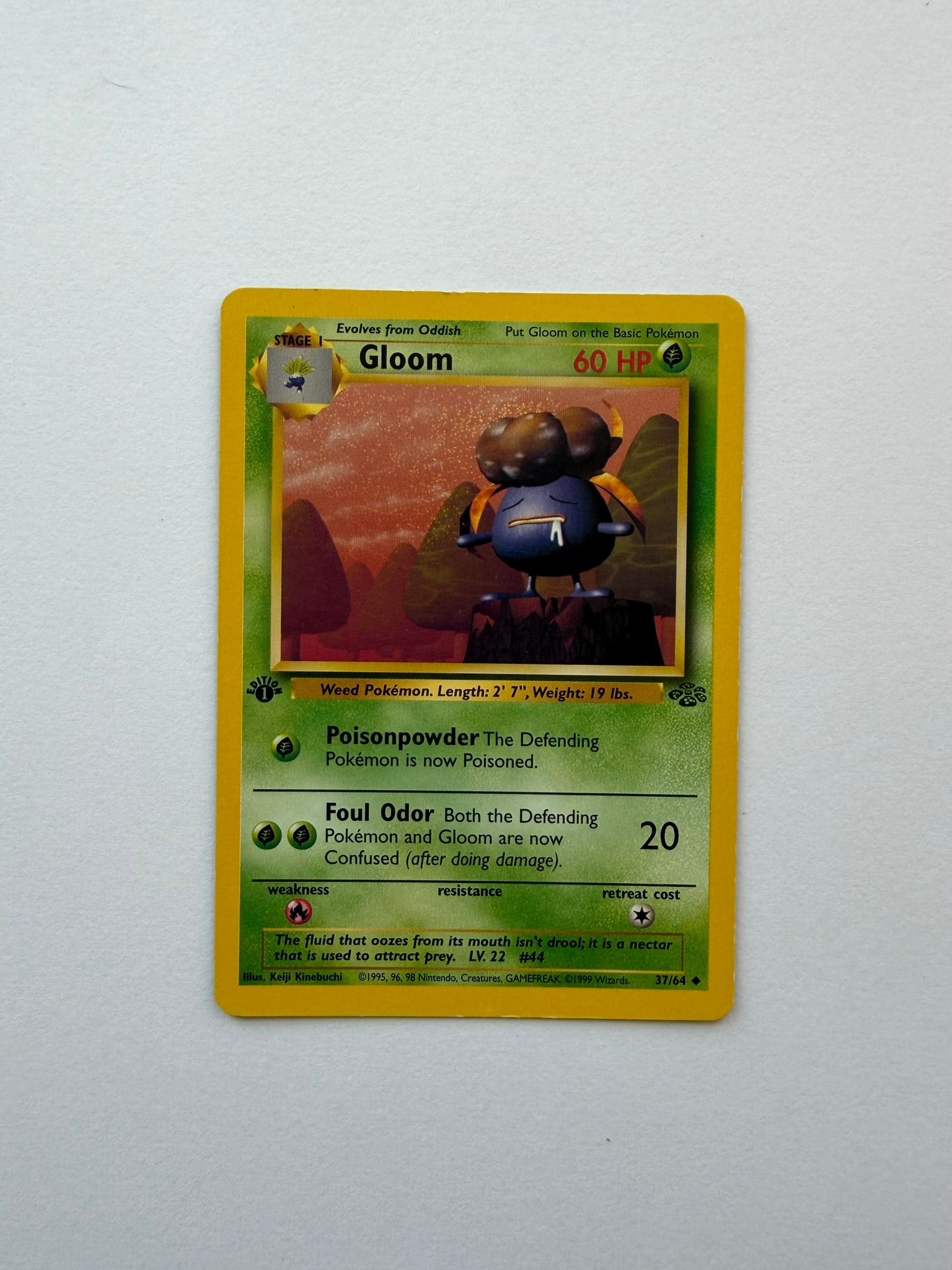 1999 Pokemon Gloom 37/64 Jungle 1st Edition: Vintage Gloom 37/64 from the 1999 Pokemon Jungle expansion. English 1st Edition non-holo uncommon featuring artwork by Keiji Kinebuchi. Ungraded with visible age-related edge and surface wear. Please 
