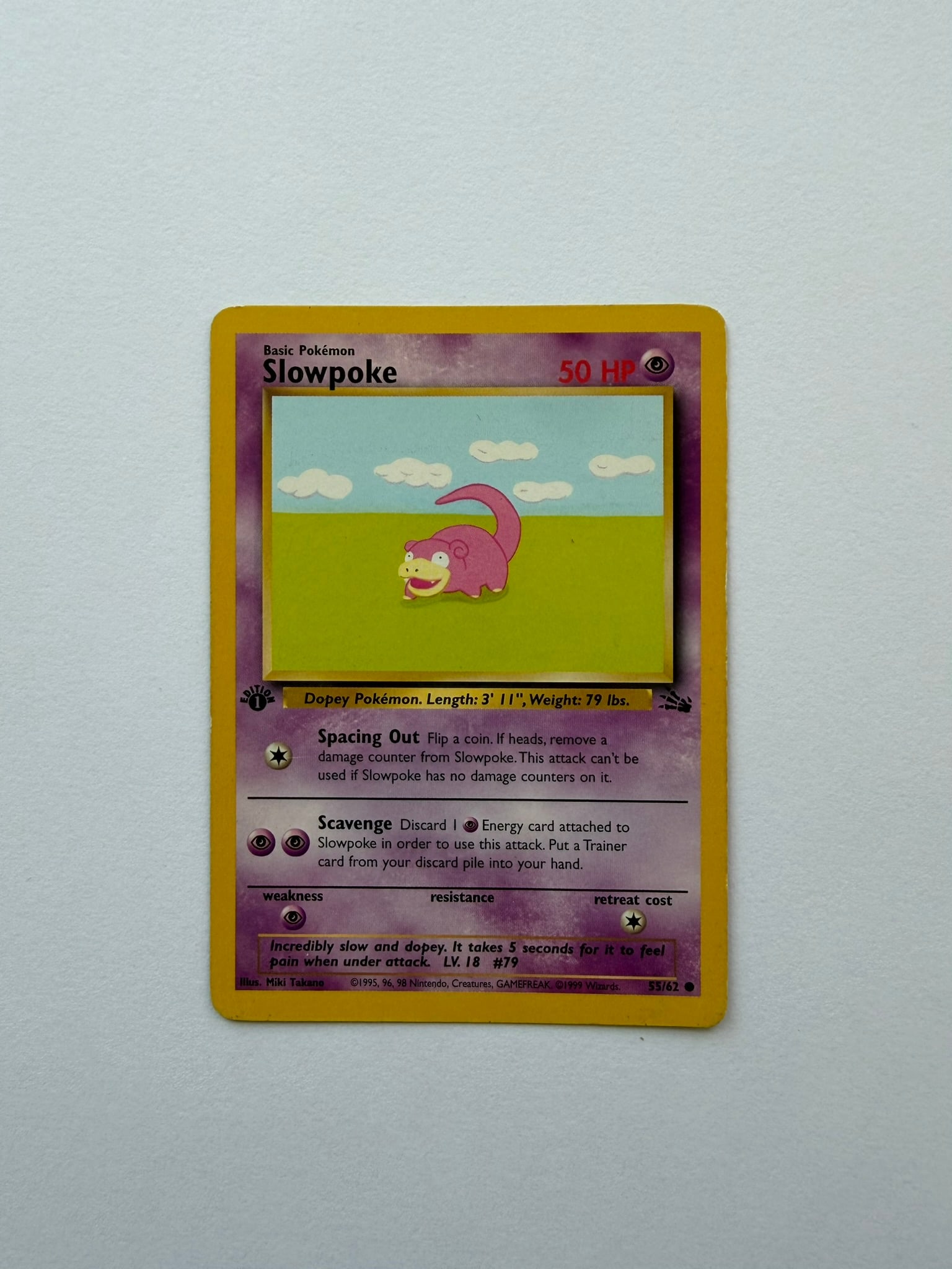 1999 Pokemon Slowpoke 55/62 Fossil 1st Edition: Vintage Slowpoke 55/62 from the 1999 Pokemon Fossil expansion. English 1st Edition common featuring artwork by Miki Tanaka. Ungraded with visible age-related edge and surface wear. Please review photo