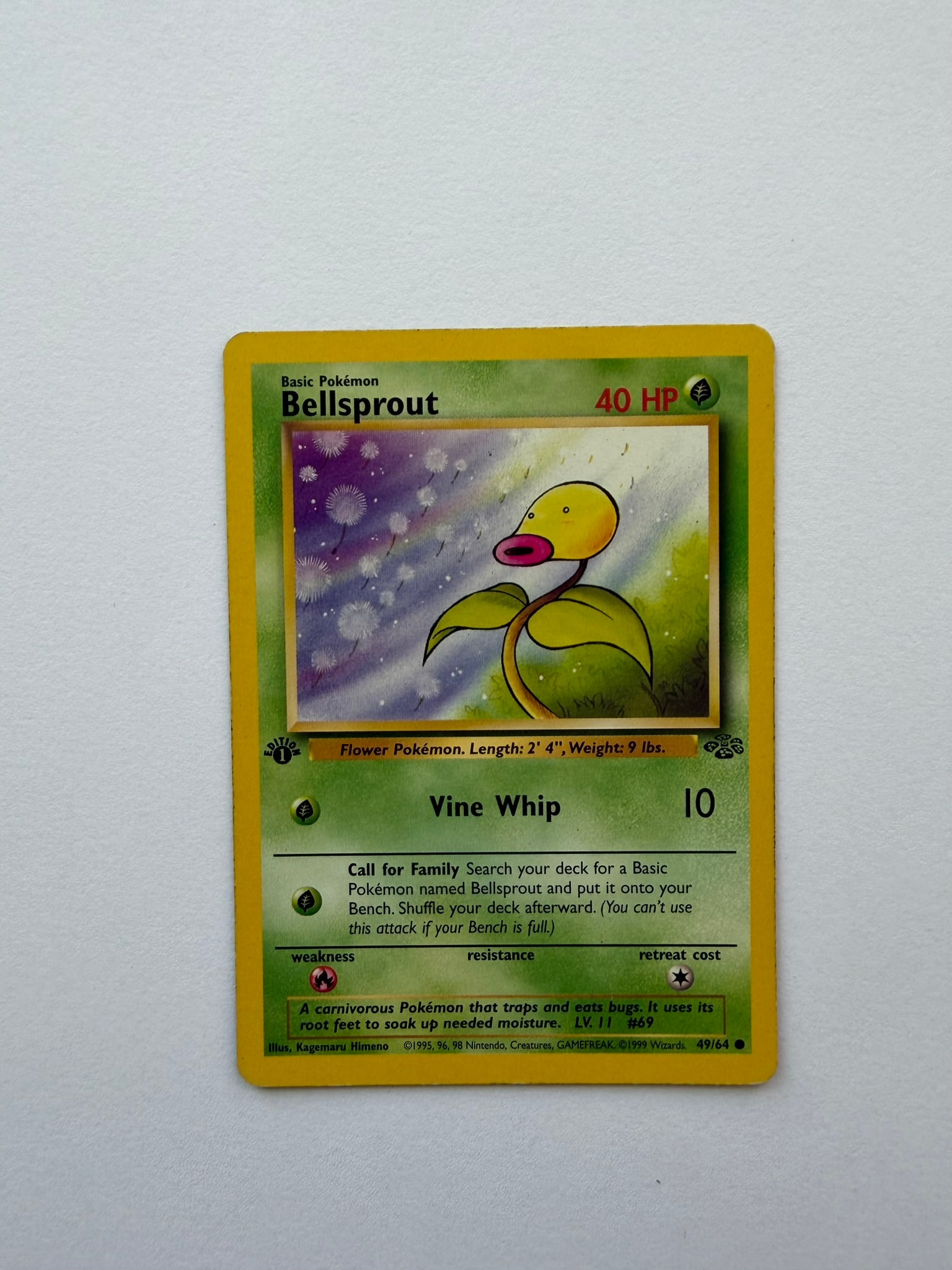 1999 Pokemon Bellsprout 49/64 Jungle 1st Edition: Vintage Bellsprout 49/64 from the 1999 Pokemon Jungle expansion. English 1st Edition common featuring artwork by Kagemaru Himeno. Ungraded with visible edge and surface wear. Please review photographs