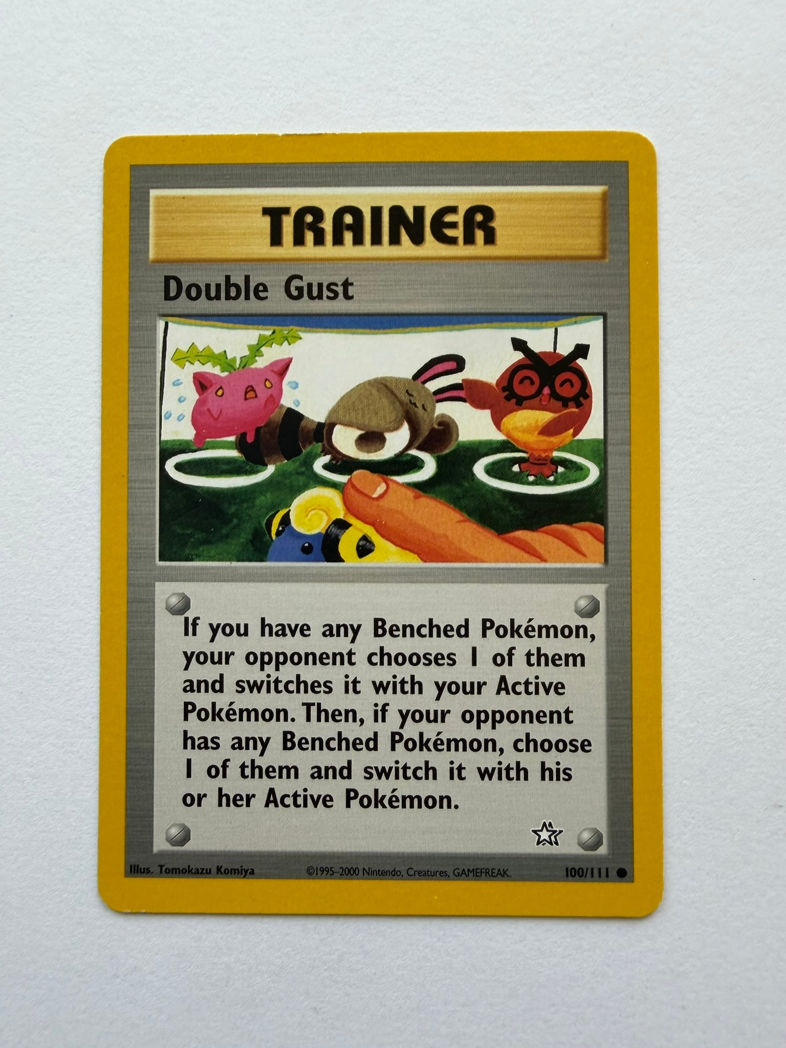 2000 Pokemon Double Gust 100/111 Neo Genesis: Double Gust 100/111 Trainer card from the 2000 Pokemon Neo Genesis expansion. Unlimited non-holo common featuring distinctive Tomokazu Komiya artwork. Ungraded with visible edge and surface wear. Plea