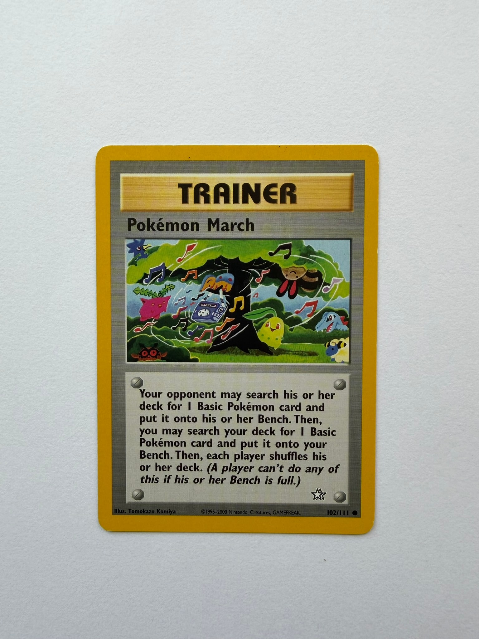 2000 Pokemon Pokemon March 102/111 Neo Genesis: Pokemon March 102/111 Trainer card from the 2000 Pokemon Neo Genesis expansion. Unlimited non-holo card featuring distinctive Tomokazu Komiya artwork. Ungraded with visible age-related edge and surfac