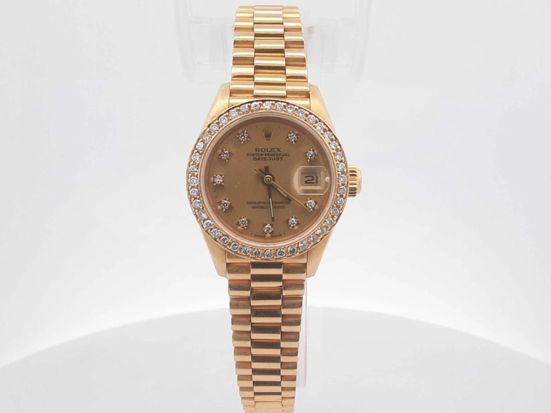 Rolex Lady-Datejust 26mm 18K Yellow Gold Diamond Bezel Wristwatch: Rolex Lady-Datejust 26mm 18K Yellow Gold Diamond Bezel Wristwatch. Luxury vintage wristwatch offered with the identifying metal, model, gemstone, and design details shown. Review photographs and avail