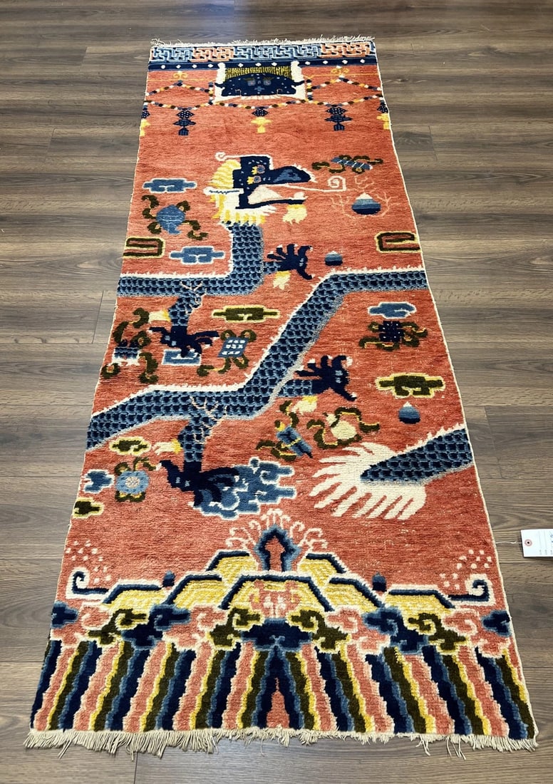 Late Qing Chinese Ningxia Five-Claw Dragon Pillar Rug: A late Qing Dynasty Chinese Ningxia pillar rug centered by a five-claw dragon above a cloud-form rainbow border. The rug retains good pile and fringe and has been recently cleaned. Measures approximat