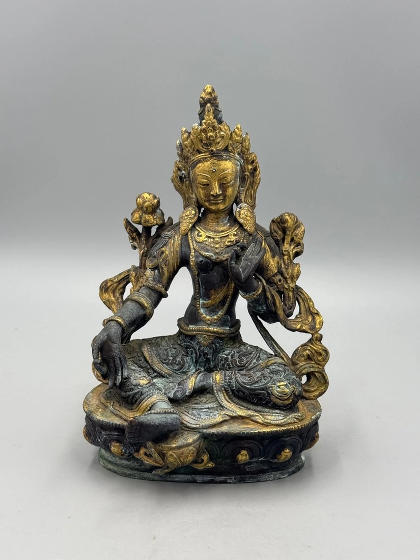 19th-Century Qing Gilt-Bronze Green Tara Statue: A 19th-century Qing Dynasty gilt-bronze Green Tara cast in red copper with partial gilding. Tara is shown in lalitasana with the right hand in abhaya mudra and the left supporting a lotus, symbolizing