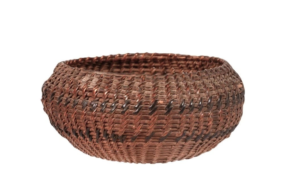 Washoe Single-Rod Rounded Basket, circa 1880: Washoe single-rod rounded basket dating to circa 1880. The basket features double bands of bracken fern root woven against a darkened willow field, with a deep aged patina. It shows very light wear an