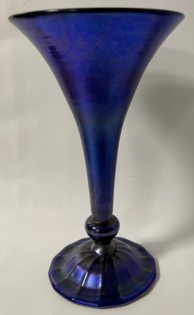 Louis C. Tiffany Furnaces Inc. Blue Favrile Glass Trumpet Vase 9017M: Antique blue Favrile glass trumpet vase with a flared rim, slender stem, rounded knop, and lobed circular foot. The underside is marked "X218 - 1533 9017M Louis C. Tiffany Furnaces Inc. Favrile." Meas