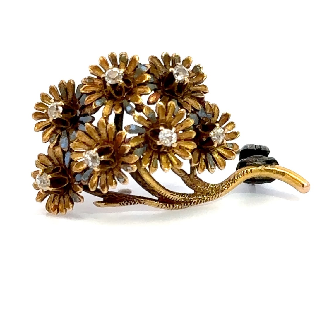 Vintage 18K Yellow Gold Floral Diamond Cluster Brooch Pin: Vintage floral brooch/pin crafted in yellow gold and set with seven natural white diamonds in old mine cuts. The diamonds are prong-set throughout the layered floral design, with an approximate total 