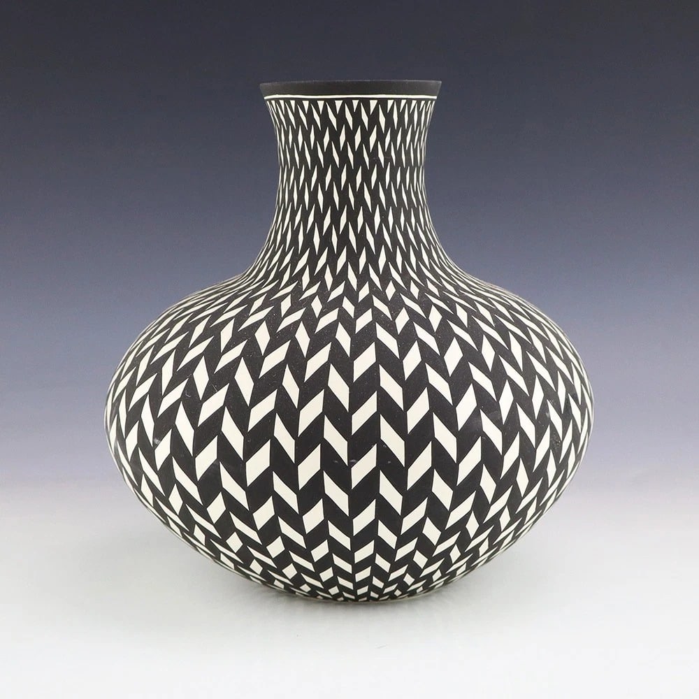 Paula Estevan Acoma Pueblo Hand-Coiled Pottery Vase: Hand-coiled and painted Acoma pottery vase by Paula Estevan, born in Acoma Pueblo in 1967 and producing pottery since 1986. The vessel features a finely repeated black-and-white geometric design acros