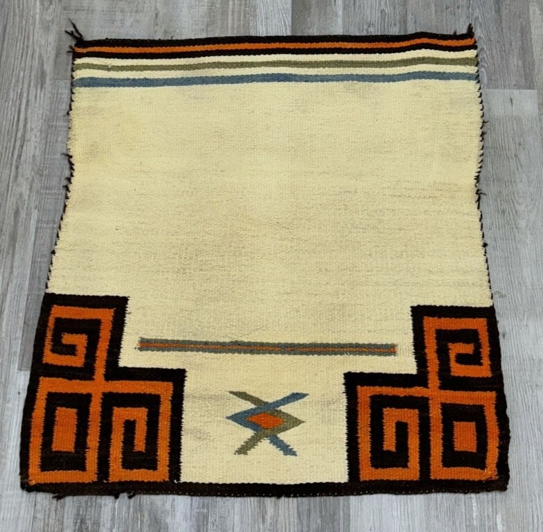 Antique Navajo Single Saddle Blanket, c. 1920-1930: Antique Navajo single saddle blanket dating to circa 1920-1930. Measures approximately 29 x 33 inches. The blanket shows expected signs of use and is described as being in good condition. Professional