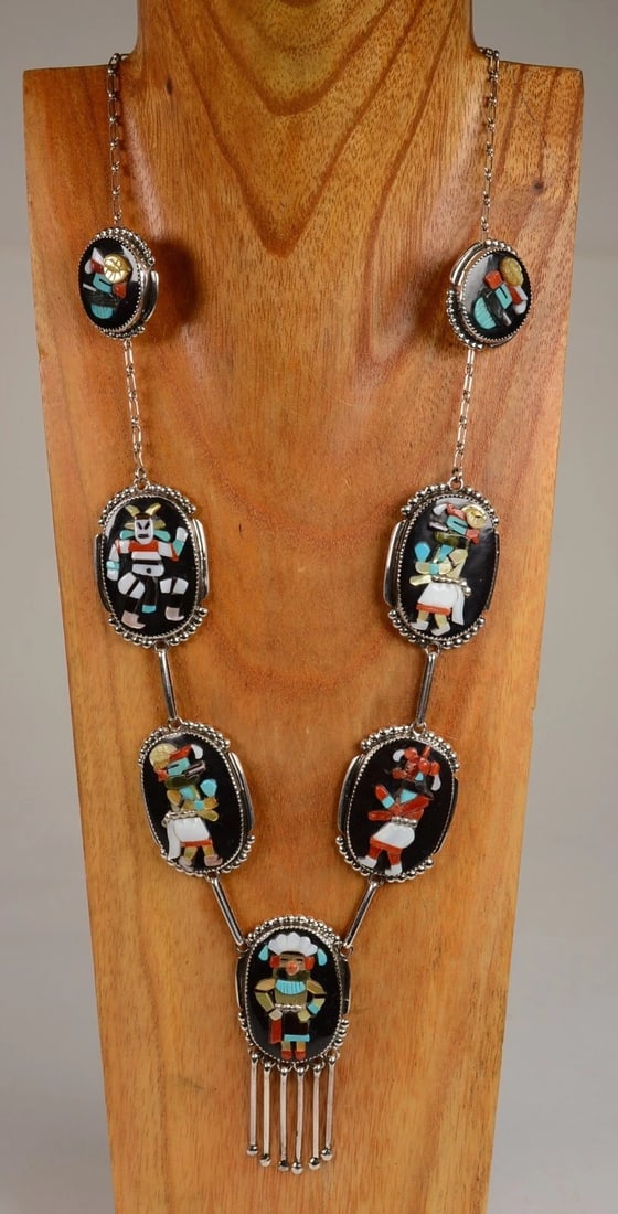 Zuni Kachina Necklace and Earrings Set By Augustine & Rosalie Pinto: Dimensions: H 1.75 x W 1.25 in. Zuni Kachina Necklace and Earrings Set By Augustine & Rosalie Pinto Late 20th Century 25 in L with each Oval 1.75 in H x 1.25 in W with the center having a total height