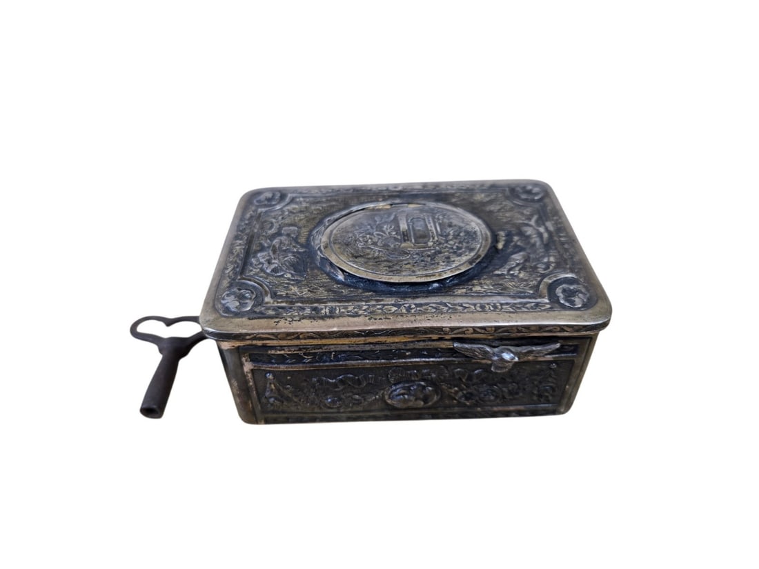 Antique Karl Griesbaum Solid 800 Silver Singing Bird Box Automaton German Music: an exceptional antique German singing bird box automaton crafted in solid 800 silver by Karl Griesbaum. The case features heavily detailed repoussé and chased relief work, depicting a romantic pastor