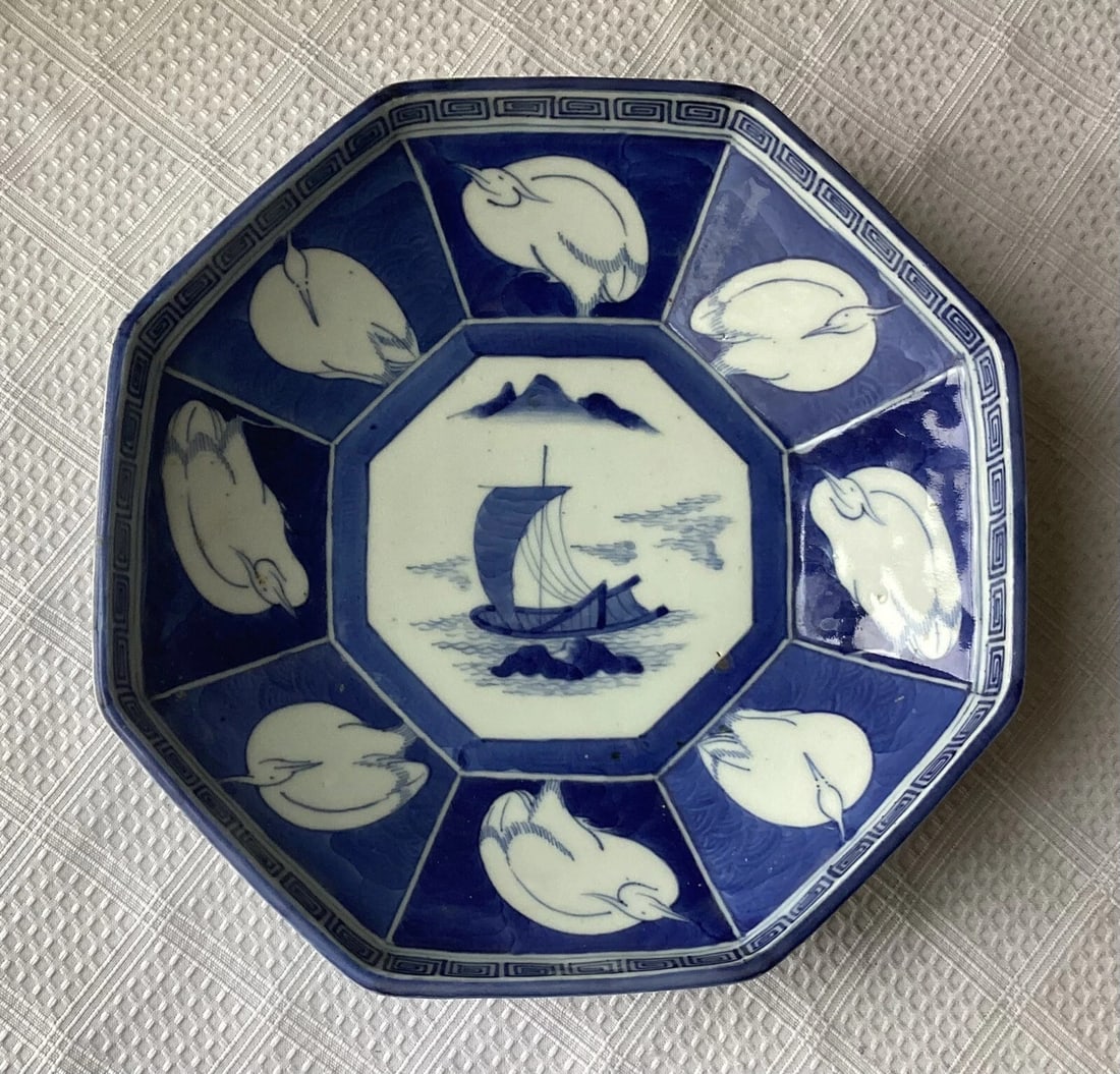 Chenghua Qing Dynasty 17th/18th-Century Porcelain Dish with Four-Character Mark: Blue-and-white porcelain dish in an octagonal form, decorated with a central sailing vessel scene surrounded by birds and framed by geometric and Greek key borders. The underside bears a