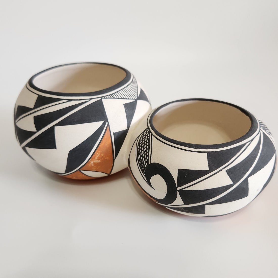 Acoma Pueblo Double-Pot Pottery Vessel, 7.75 in: Acoma Pueblo double-pot pottery vessel from New Mexico, formed as two attached pots with hand-painted decorative detail. Approximate size is 7.75 inches long by 3.25 inches high. The piece is