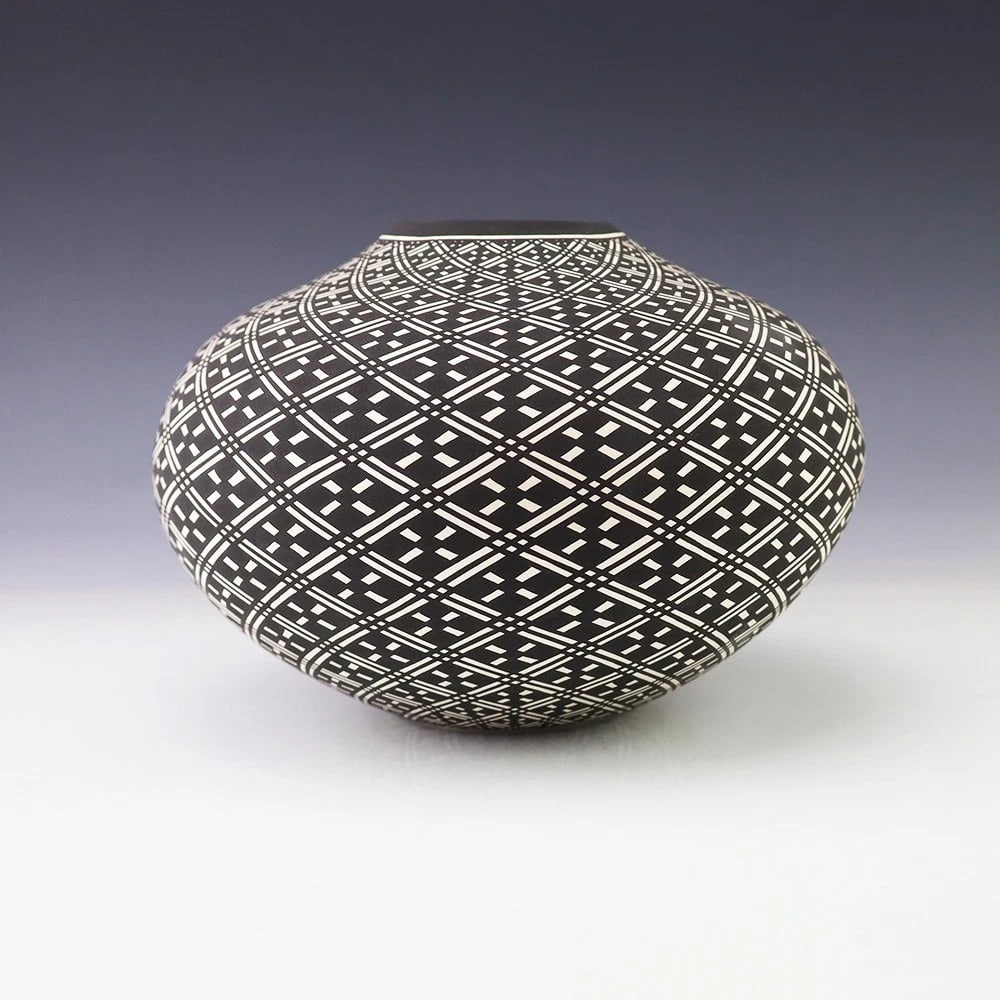 Paula Estevan Acoma Pottery Vase, Signed: Handmade Acoma pottery vase by Paula Estevan, featuring a finely painted black-and-white geometric lattice design across the rounded body. The vessel is signed and includes an artist card. Measures ap