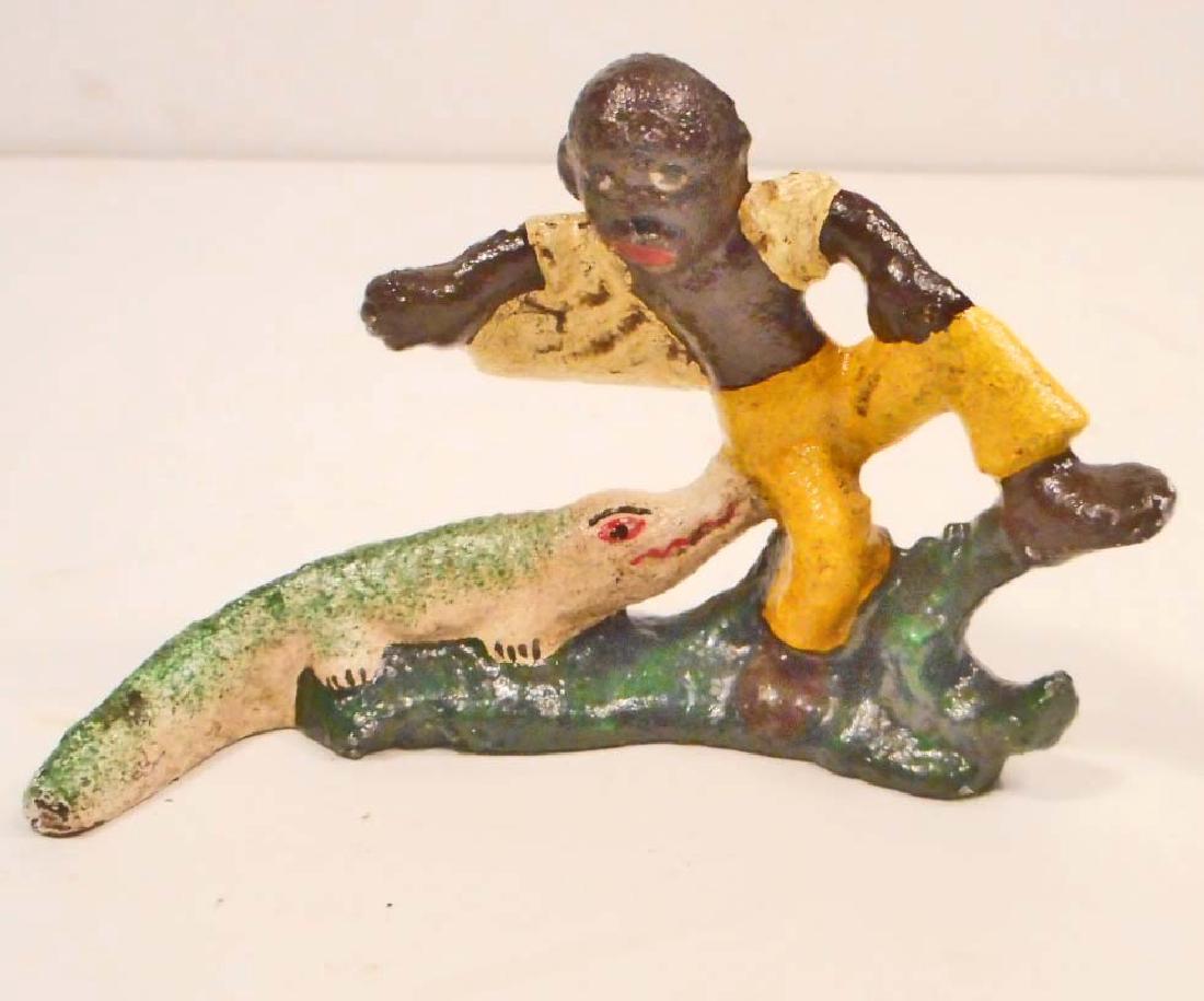 CAST IRON BLACK AMERICANA BOY W/ ALLIGATOR BOTTLE: 4" LONG