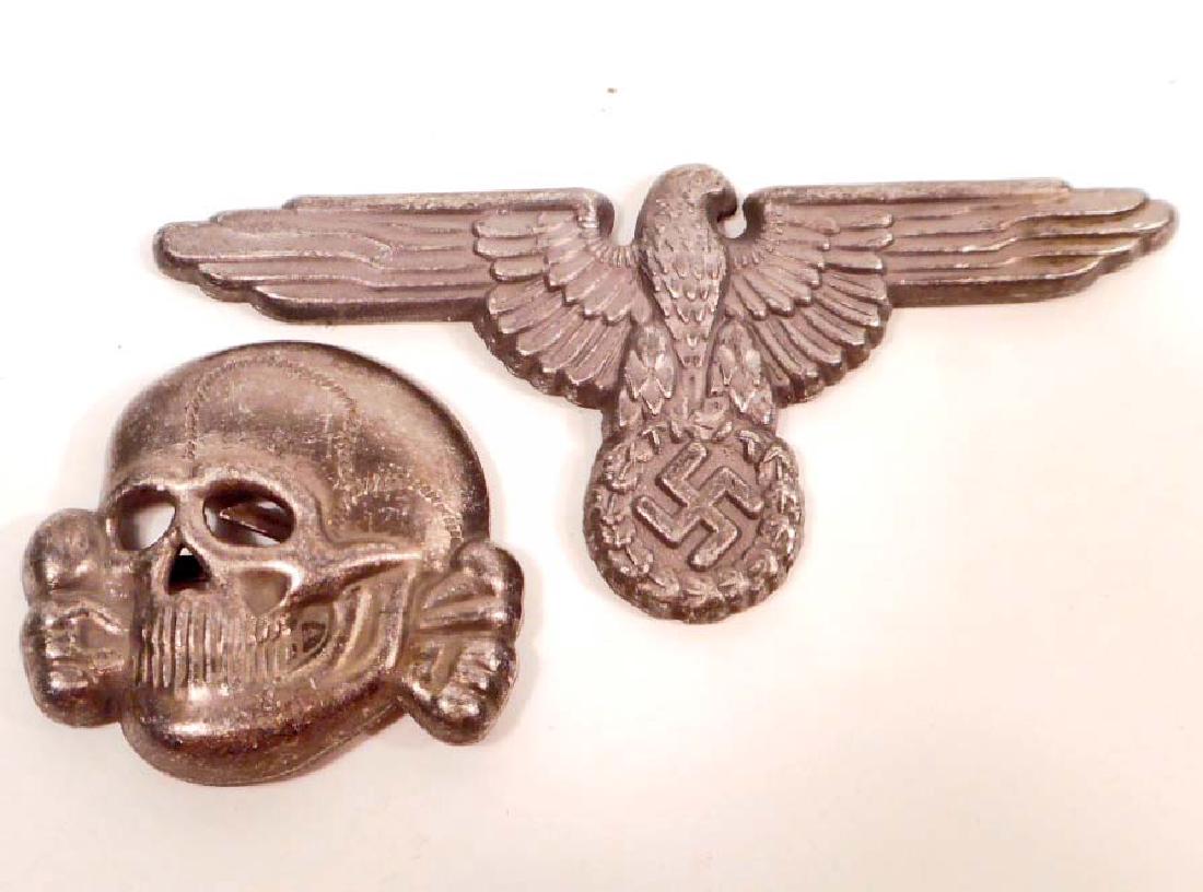GERMAN NAZI WAFFEN SS OFFICERS VISOR CAP EAGLE & SKULL: They are maker marked 'RZM M1/52'. Both have Two (2) flat horizontal prongs on the reverse side. Stamped nickel construction.