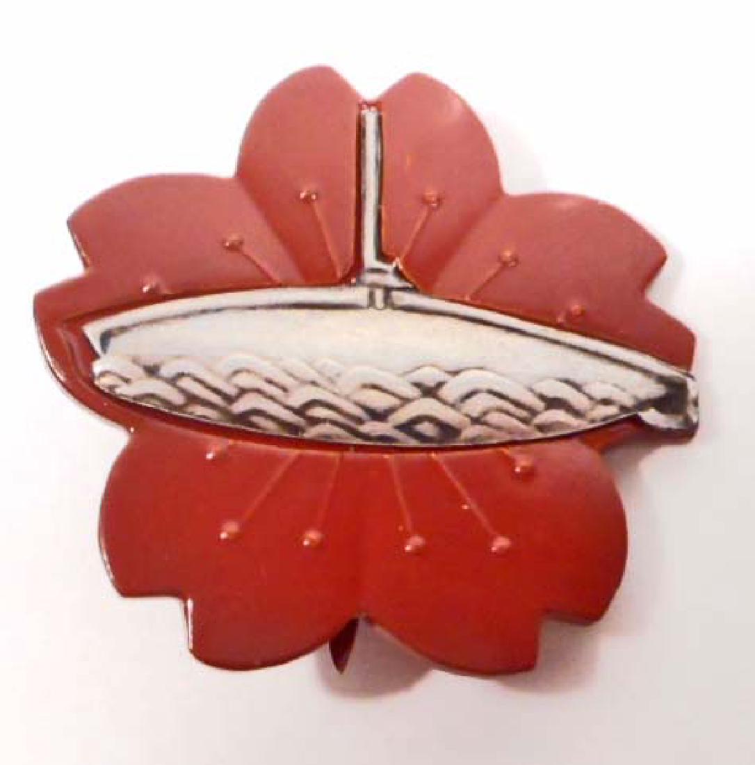 IMPERIAL JAPANESE NAVAL SUBMARINE SAILOR BADGE: Measures 1 1/2" wide by 1 7/16" tall. The front shows the profile of a submarine with a chrysanthemum in the back ground. Has a wide vertical pin back. Nickel and bronze construction.