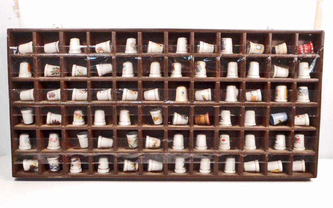LOT OF 72 VINTAGE THIMBLES ON A WOODEN THIMBLE SHELF: Thimbles are various Souvenirs. Shelf is 10.5" by 22.5"