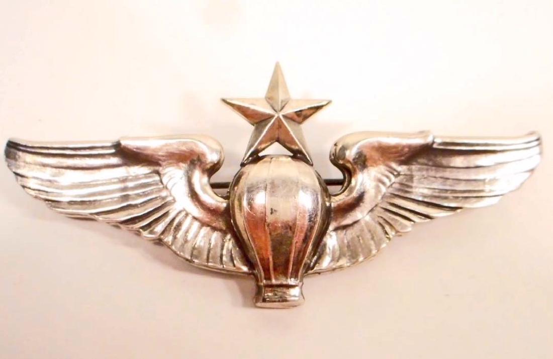 USAAF ARMY AIR FORCE SENIOR BALLOON PILOT WING: Measures 3 3/16" wide by 1 7/16" tall. The reverse side is maker marked 'Meyer New York' in their shield logo. It is also marked 'Sterling'. Has a thin horizontal pin back. Mounted on an original Meye