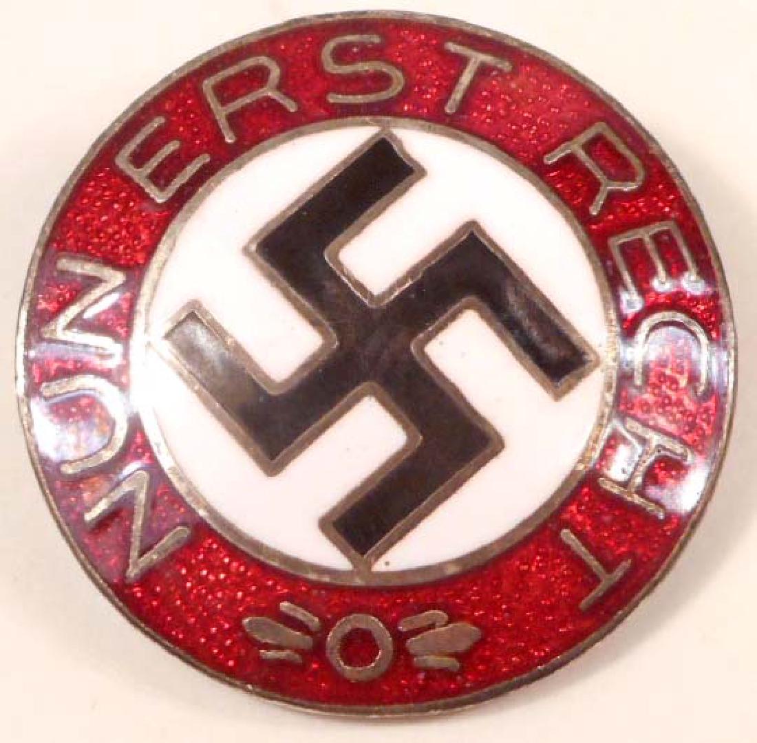 GERMAN NAZI NUN ERST RECHT LAPEL PARTY BADGE: Measures 7/8" in diameter. The front reads 'Nun Erst Recht' and has a swastika in the center. The reverse side is maker marked 'RZM M1/4 ges gesch'. Has a thin horizontal pin back. Nickel construction