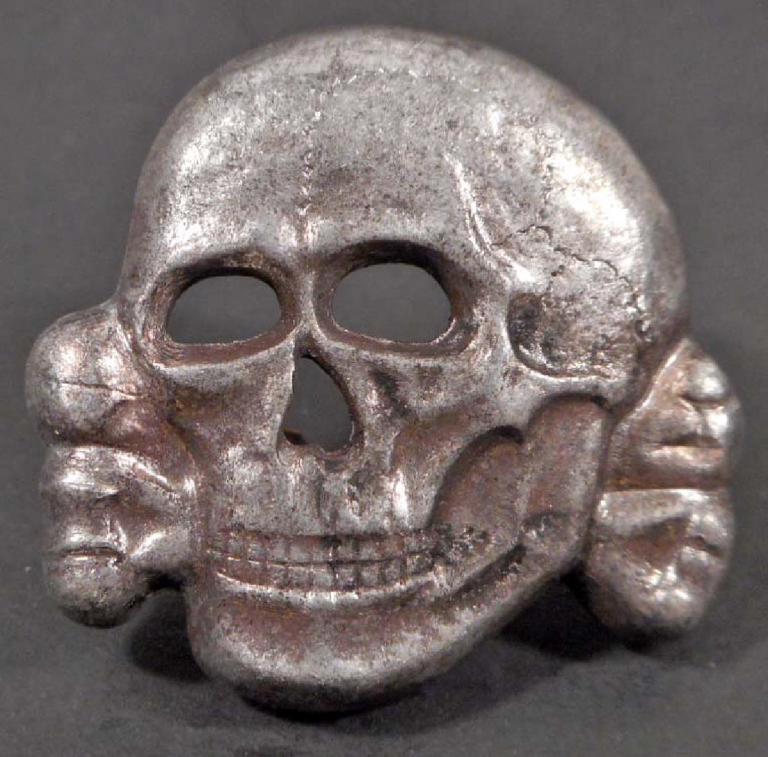 GERMAN NAZI WAFFEN SS SHULTSSTAFFEL OFFICERS VISOR CAP: The reverse side is maker marked 'RZM M1/24'. Has Two (2) crimped flat horizontal prongs on the reverse side. Stamped nickel construction.
