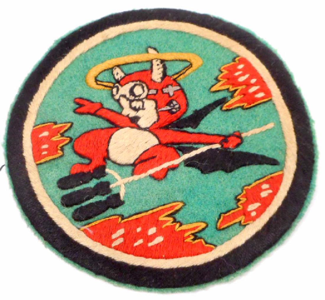 USAAF ARMY AIR CORPS BOMB SQUADRON PATCH: Measures 4 1/2" in diameter. Shows a devil with a halo holding Three (3) bombs in his pitch fork. Hand and machine embroidered on a wool backing. This was to have been worn on the front breast of an A