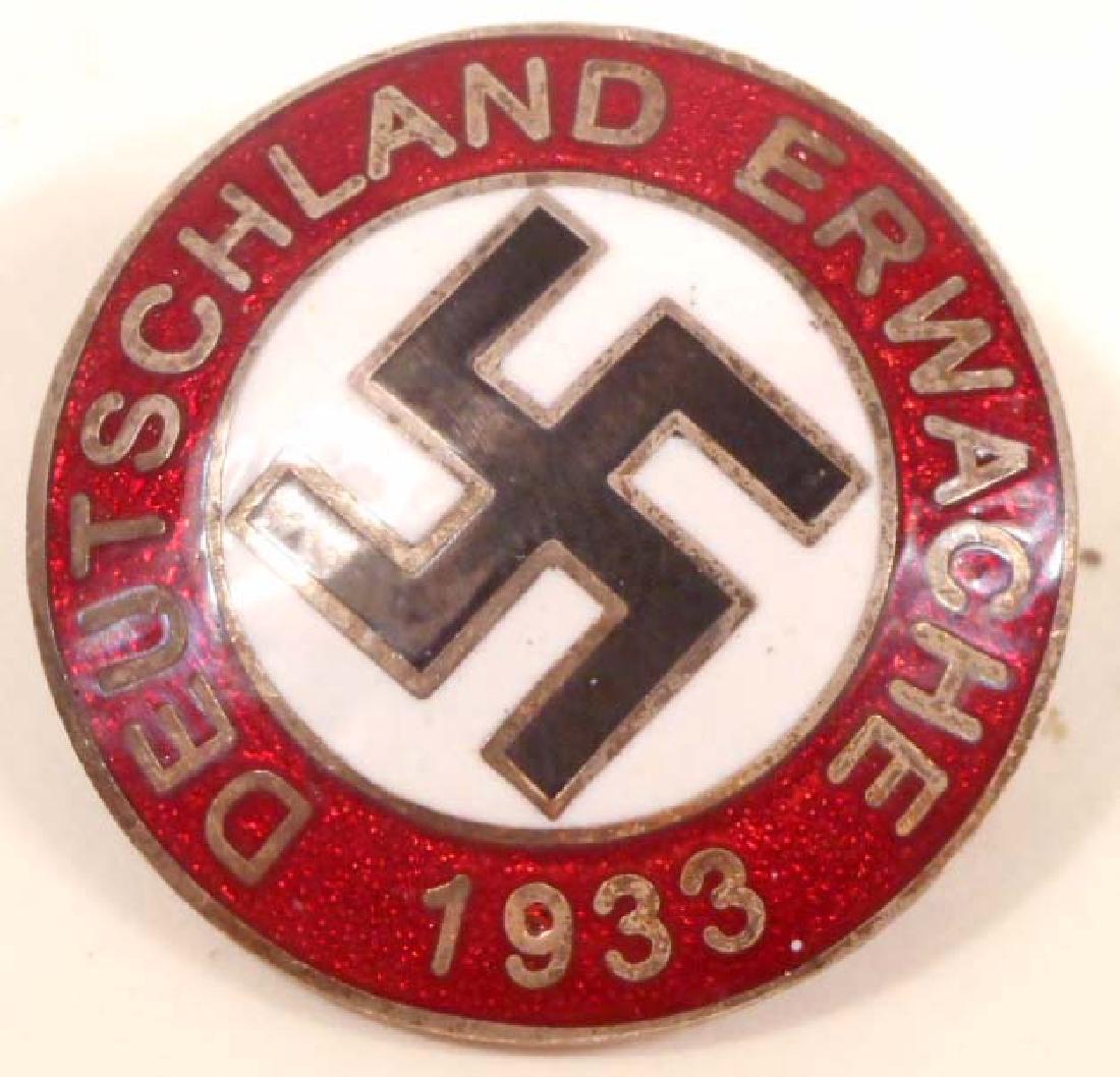GERMAN NAZI DEUTSCHLAND ERWACHE PARTY LAPEL BADGE: Measures 15/16" in diameter. The front reads 'Deutschland Erwache 1933' and has a swastika in the center. Maker marked 'RZM M1/29'. Has a thin horizontal pin back. Nickel construction with enamel.