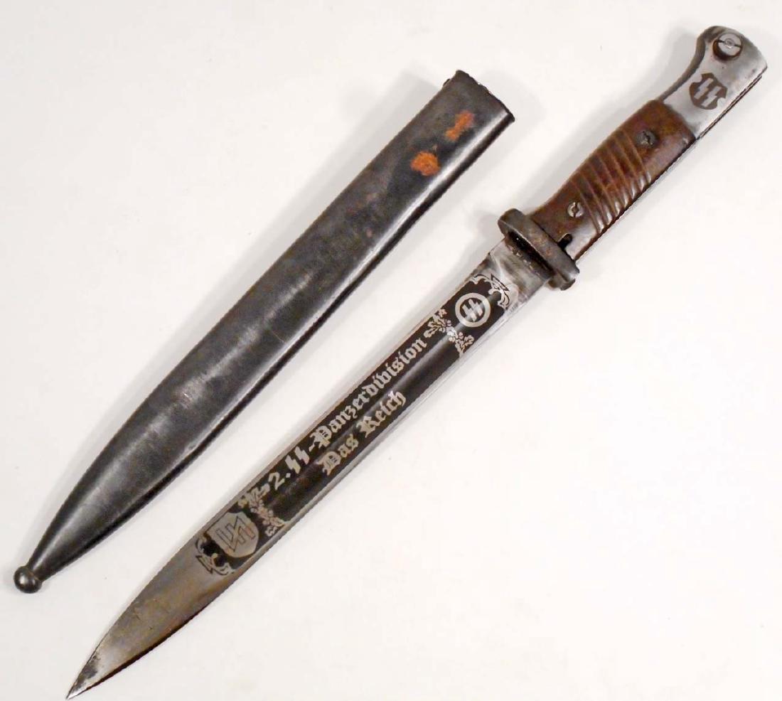 GERMAN NAZI WAFFEN SS DAS REICH PRESENTATION ENGRAVED: Measures 16" long overall. The engraved blade reads '2. SS - Panzerdivision Das Reich'. It is marked '44 cvl 4092 m'. It measures 1" wide by 9 7/8" long. Includes the blued steel scabbard that measure