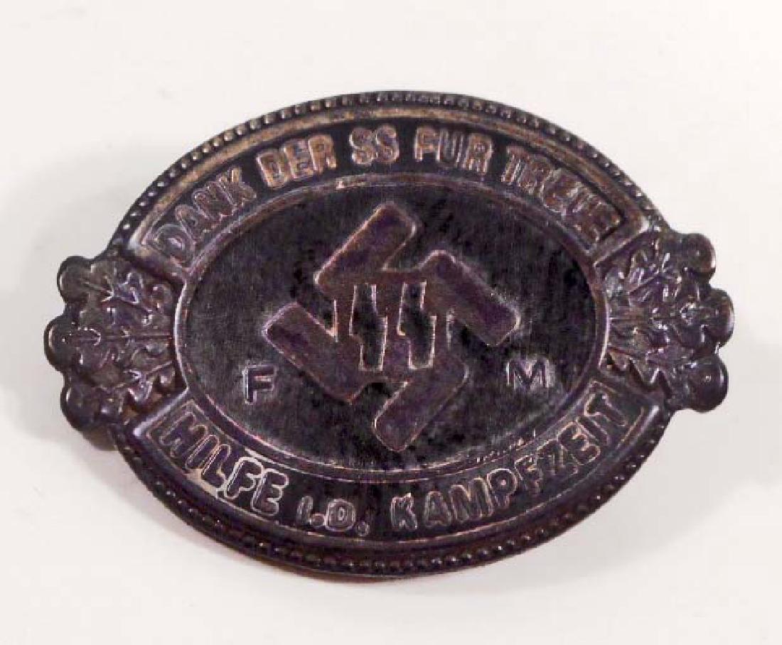 GERMAN NAZI WAFFEN SS FM PARTY BADGE: Measures 1" wide by 3/4" tall. The reverse side is maker marked 'RZM M1/133'. Has a thin horizontal pin back. Nickel construction with enamel.