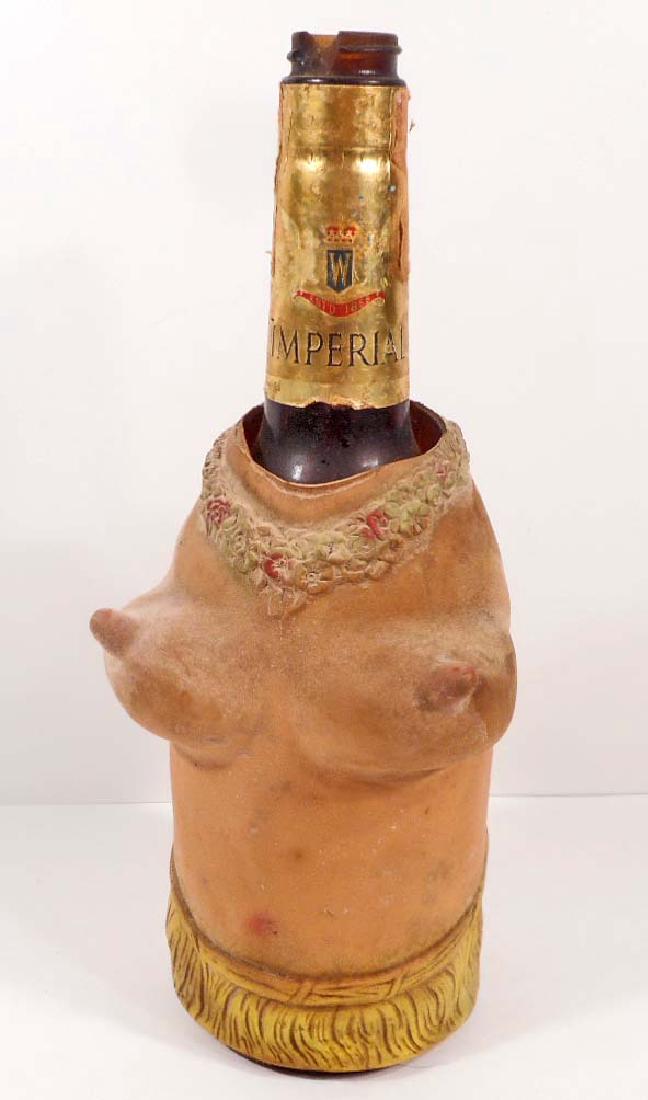 VINTAGE WINE BOTTLE W/ RISQUE COVER ON BOTTLE: rubber type material of what appears to be a Hawaiian ladies boobies and bottom