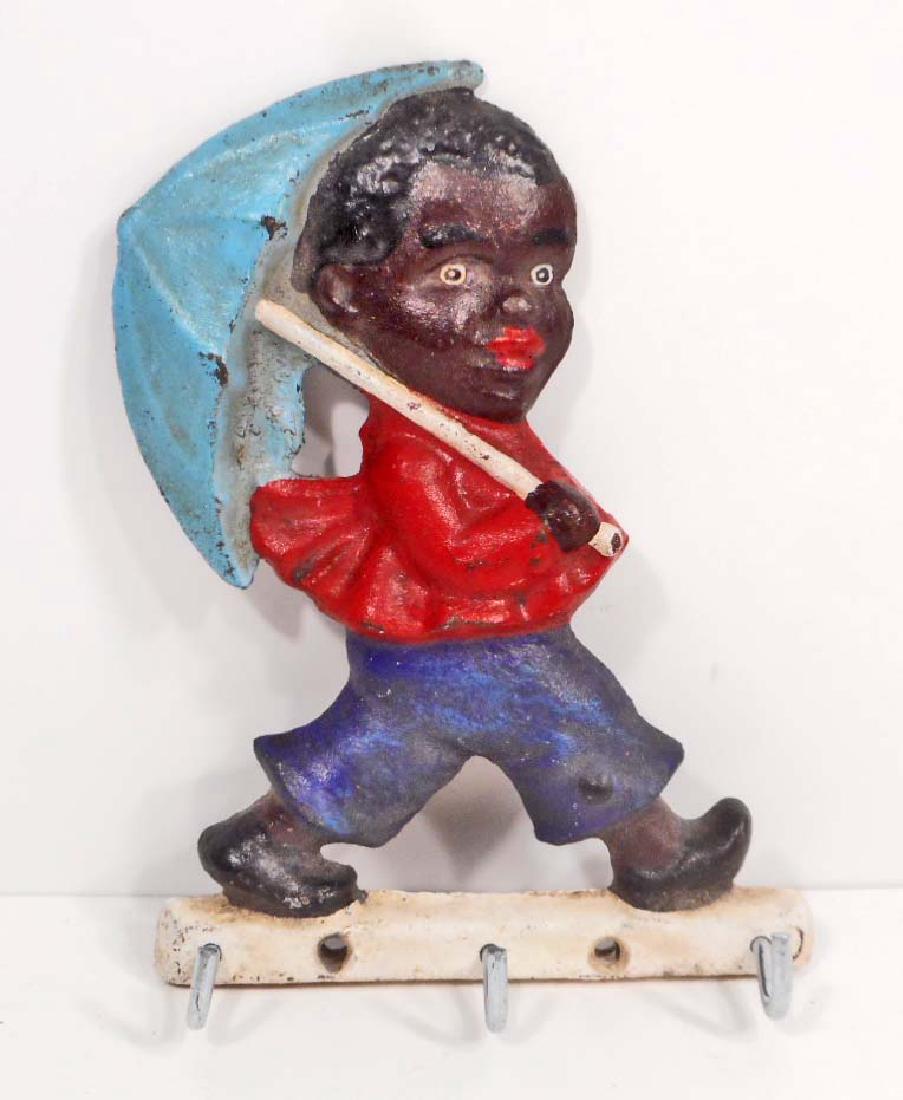 CAST IRON BLACK AMERICANA BOY W/ UMBRELLA HOOKS: 6.5" tall