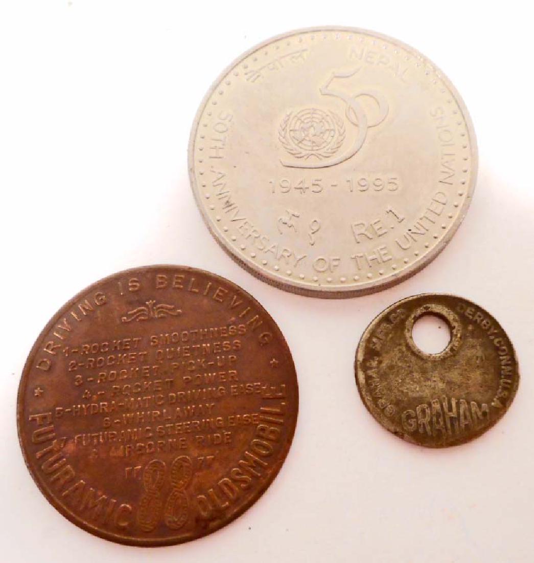 LOT OF 3 VINTAGE TOKENS / COINS: Futurama Old's 88, Graham Mfg C Derby Connectict and Nepal 50th Anniversary of the United Nations.