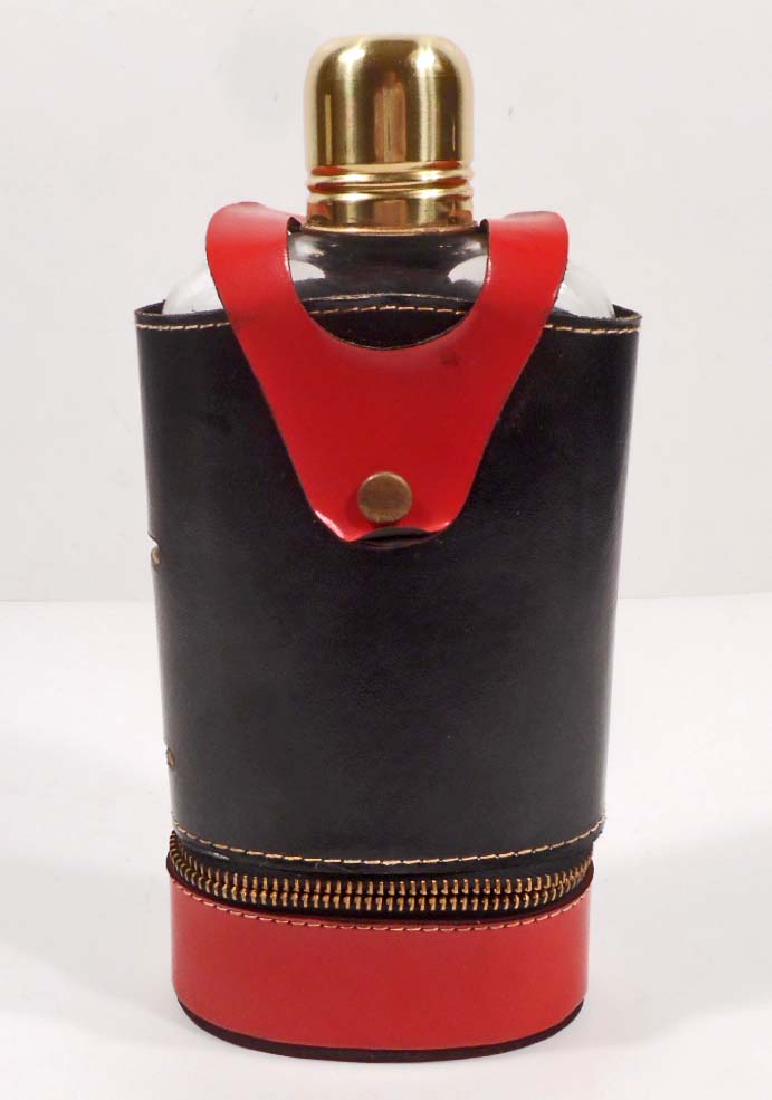 VINTAGE GLASS FLASK & SHOT GLASS CUP SET: Red & Black cover snaps off of glass flask. Bottom part has a zipper that hold 2 small plasticd cups each marked with "A Thimble Full" on the bottom.