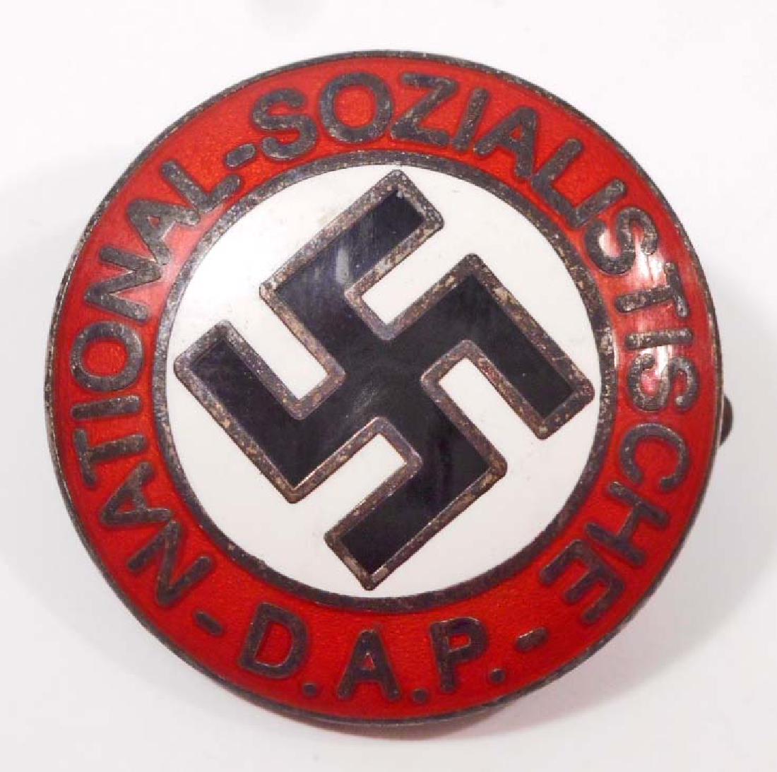 GERMAN NAZI NSDAP LAPEL PARTY BADGE: . Measures 15/16" in diameter. The front reads 'National - Sozialistische DAP'. Has a swastika in the center. The reverse side is maker marked 'RZM M1/129'. Has a thin horizontal safety pin back. Nick