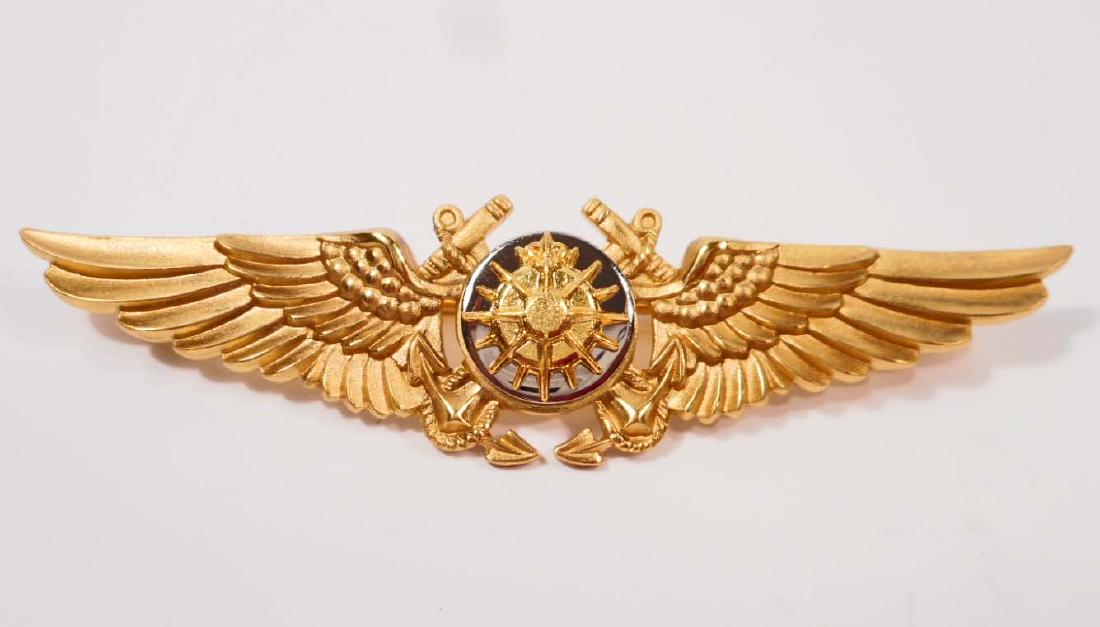 USN NAVAL NAVIGATOR WING: Measures 2 3/4" wide by 11/16" tall. The front shows a star burst in the center with a pair of anchors in the back ground and is flanked by a wing on each side. The reverse is maker marked 'NS Meyer I
