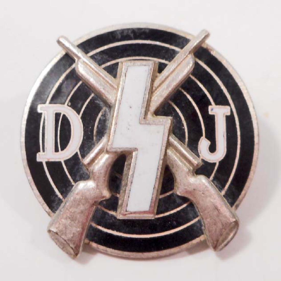 GERMAN NAZI DEUTSCHES YOUTH DJ MARKSMAN SHOOTING AWARD: Measures 7/8" in diameter. The front has a runic in the center with a pair of crossed rifles in the back ground mounted onto a bulls eye. Has the letters 'DJ' on each side. The reverse is maker marked