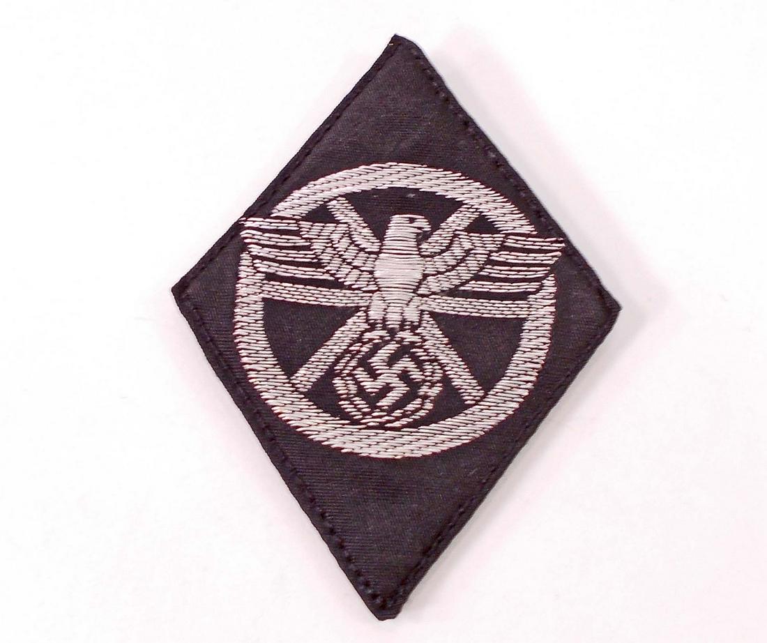 GERMAN NAZI NSKK MOTORIZED KORPS OFFICERS SLEEVE: Measures 1 7/8" wide by 2 1/2" tall. The front shows a political eagle in the center of a circle. Flat silver bullion wire machine embroidered on a black cotton back ground. This was to have been worn