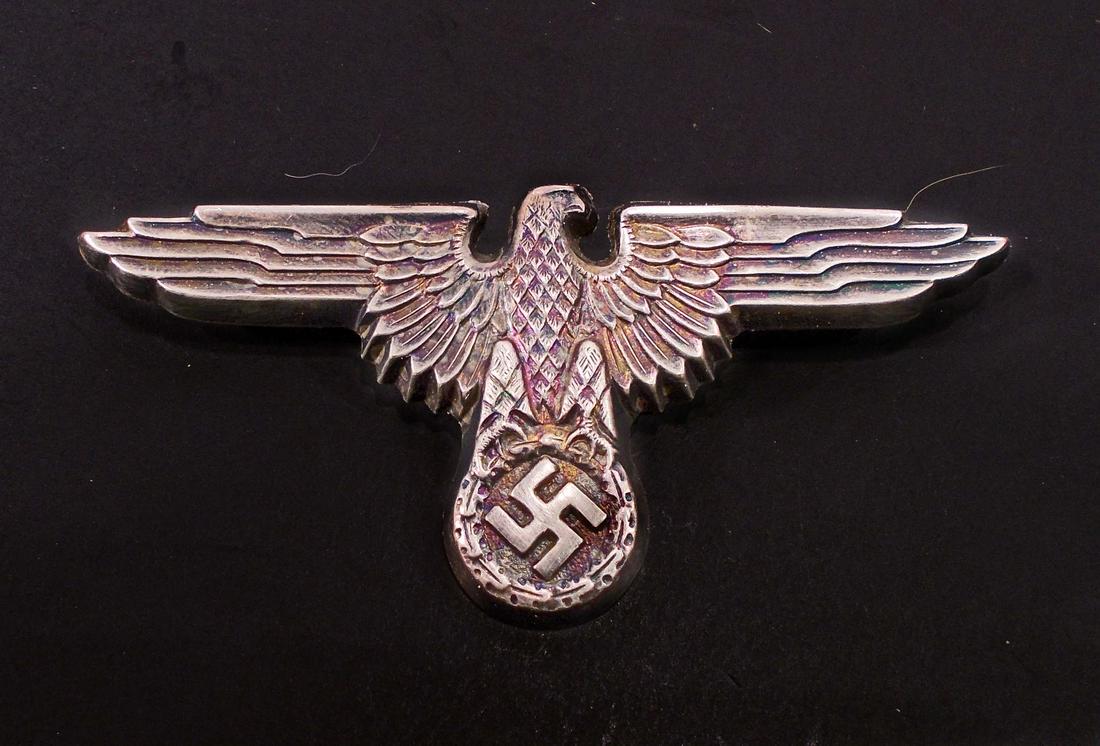 GERMAN NAZI WAFFEN SS OFFICER VISOR CAP EAGLE: The reverse side is maker marked 'RZM M1/14'. Has Two (2) flat horizontal prongs crimped in place on the reverse side. Stamped nickel construction