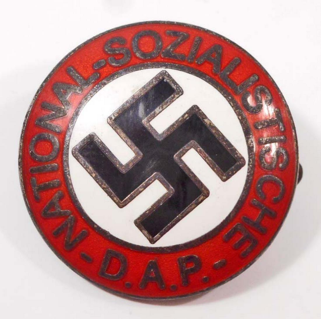 GERMAN NAZI NSDAP LAPEL PARTY BADGE: . Measures 15/16" in diameter. The front reads 'National - Sozialistische DAP'. Has a swastika in the center. The reverse side is maker marked 'RZM M1/129'. Has a thin horizontal safety pin back. Nick