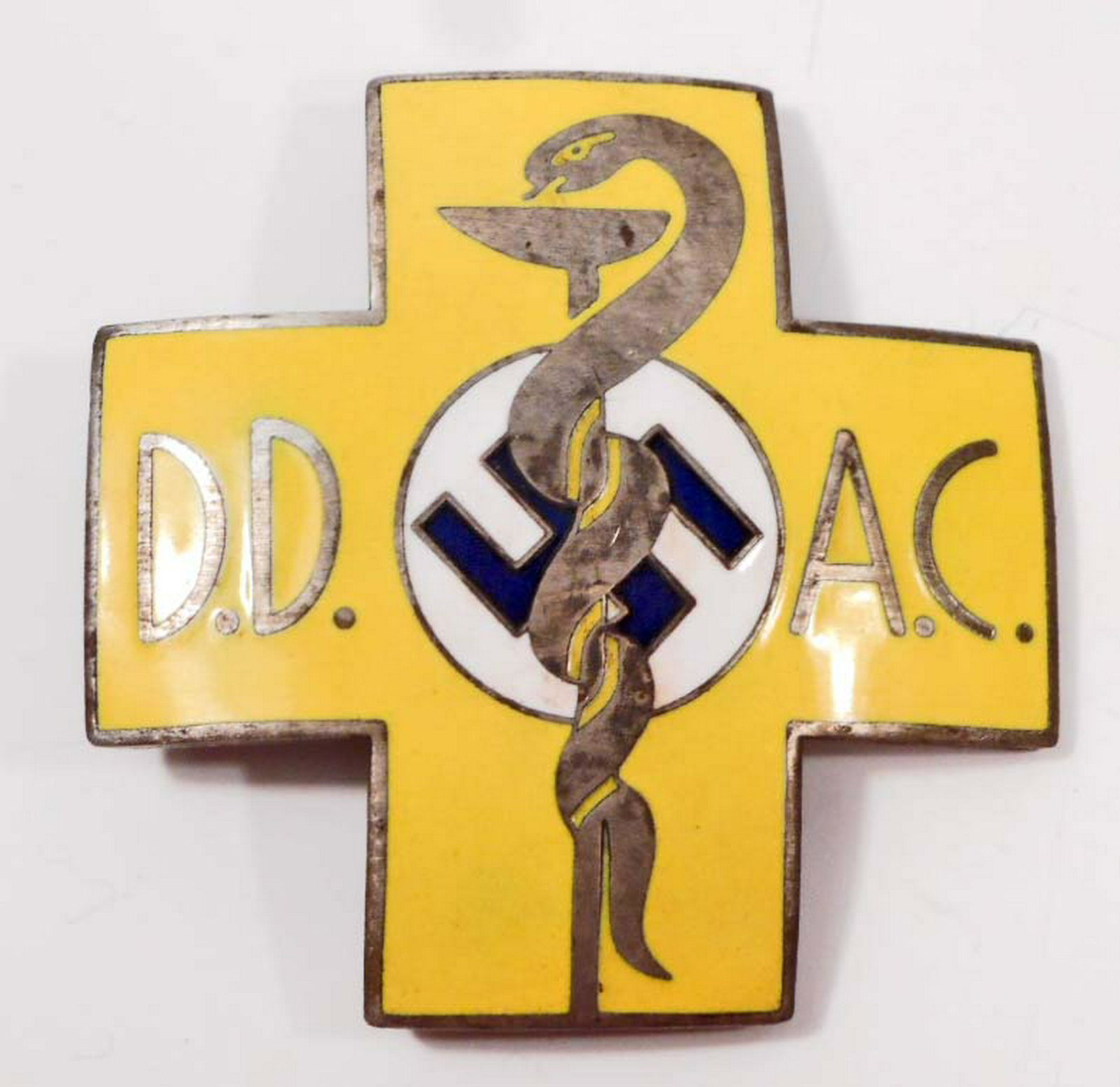 GERMAN NAZI MEDICAL DOCTOR DD AC BREAST BADGE: Measures 1 7/8" wide by 1 7/8" tall. The front shows a snake wrapped around a beaker with the letters 'DD AC' on each side. The reverse is maker marked 'Carl Poellath Schrobenhausen # 46'. Has a thin 