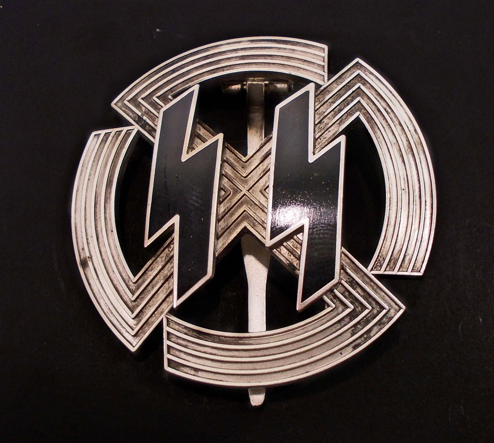 GERMAN NAZI WAFFEN SS SILVER PROFICIENCE BADGE: Front shows a pair of ss runics in the center of a cog wheel swastika. Reverse side is maker marked Richard Sieper & Sohne Ludenscheid RZM M1/25. Wide vertical pinback. 3 piece nickel construction wit