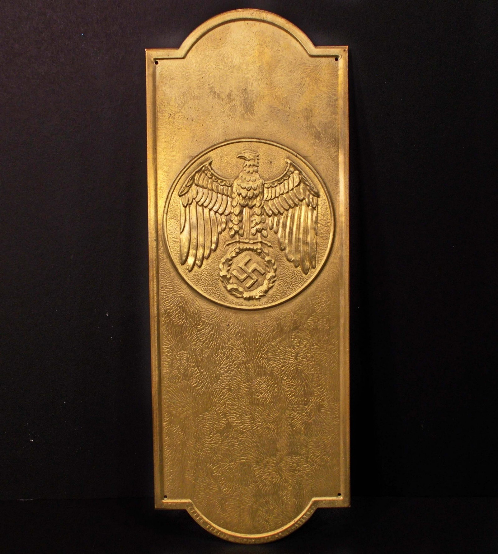 GERMAN NAZI POLITICAL LEADER EAGLE DOOR PLAQUE: Measures 3 3/4" wide by 10 1/16" tall. The front shows a Political Leader eagle clutching a swastika in his talons. Stamped brass construction.