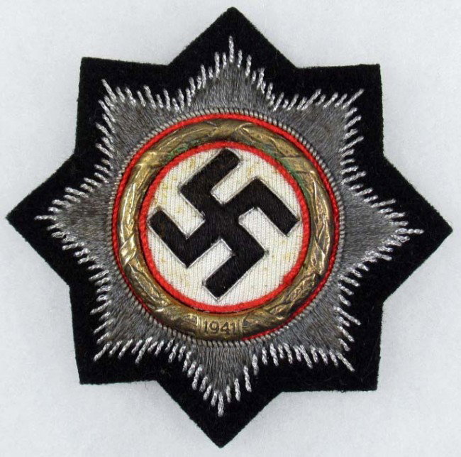 WW2 GERMAN NAZI PANZER CLOTH GERMAN CROSS IN GOLD: WW2 GERMAN NAZI PANZER CLOTH GERMAN CROSS IN GOLD - Approx. 3.25" diameter. Metal wreath is dated 1941. Badge was awarded to a soldier in the tank corps.