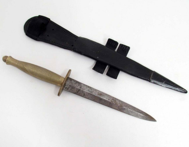 WW2 BRITISH ARMY FAIRBORNE SYKES COMBAT KNIFE W/ SC: Approx. 13.25" long overall. Brass handle w/ steel blade. Leather scabbard w/ steel tip.