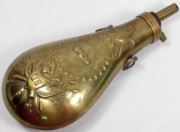 US PEACE GUN POWDER FLASK: Measures 3 7/8" by 9". Brass construction. Has a military motif with crossed cannons, flags, swords, helmet, & arrows. Has an American Eagle at the top.